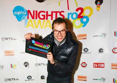 nights awards 2009: dj optick showing his award diploma in front of the logo wall (spider)